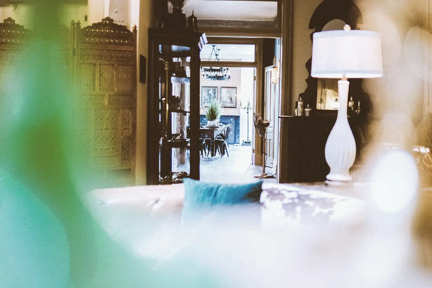 Layered interior view through rooms with lamp and architectural depth