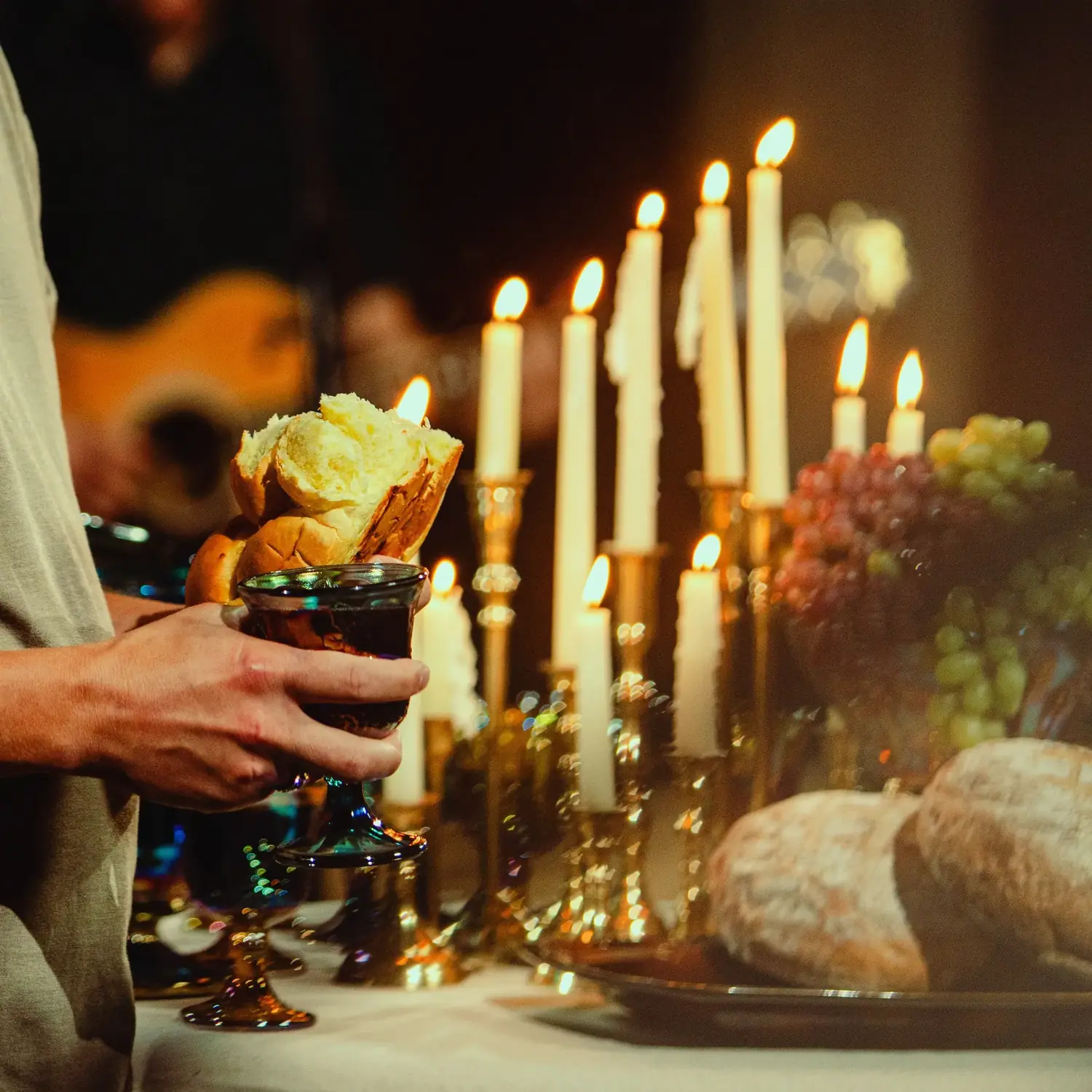 Formal dining event — long table set with candles, florals, and fine linens