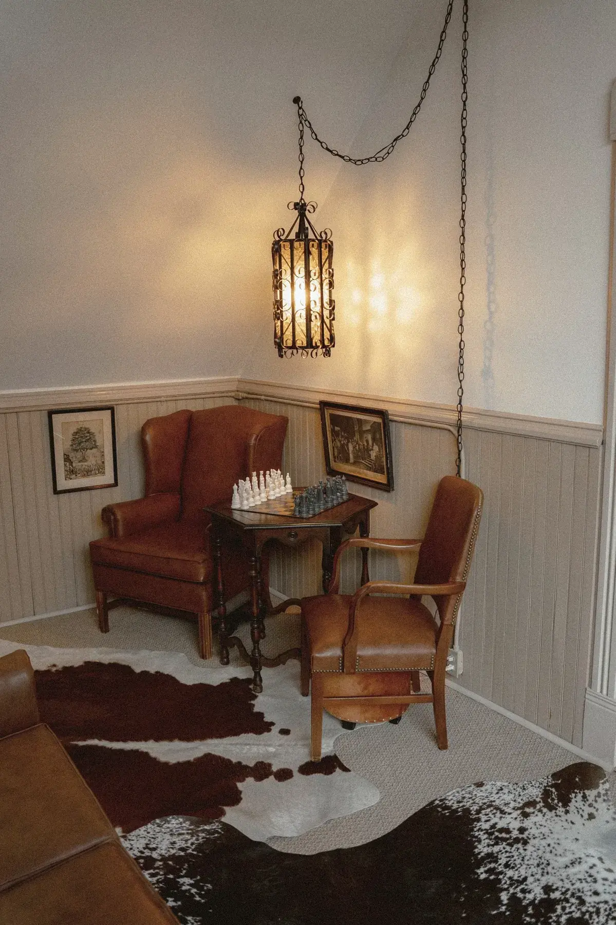 Chess nook with leather wingback and hanging lantern