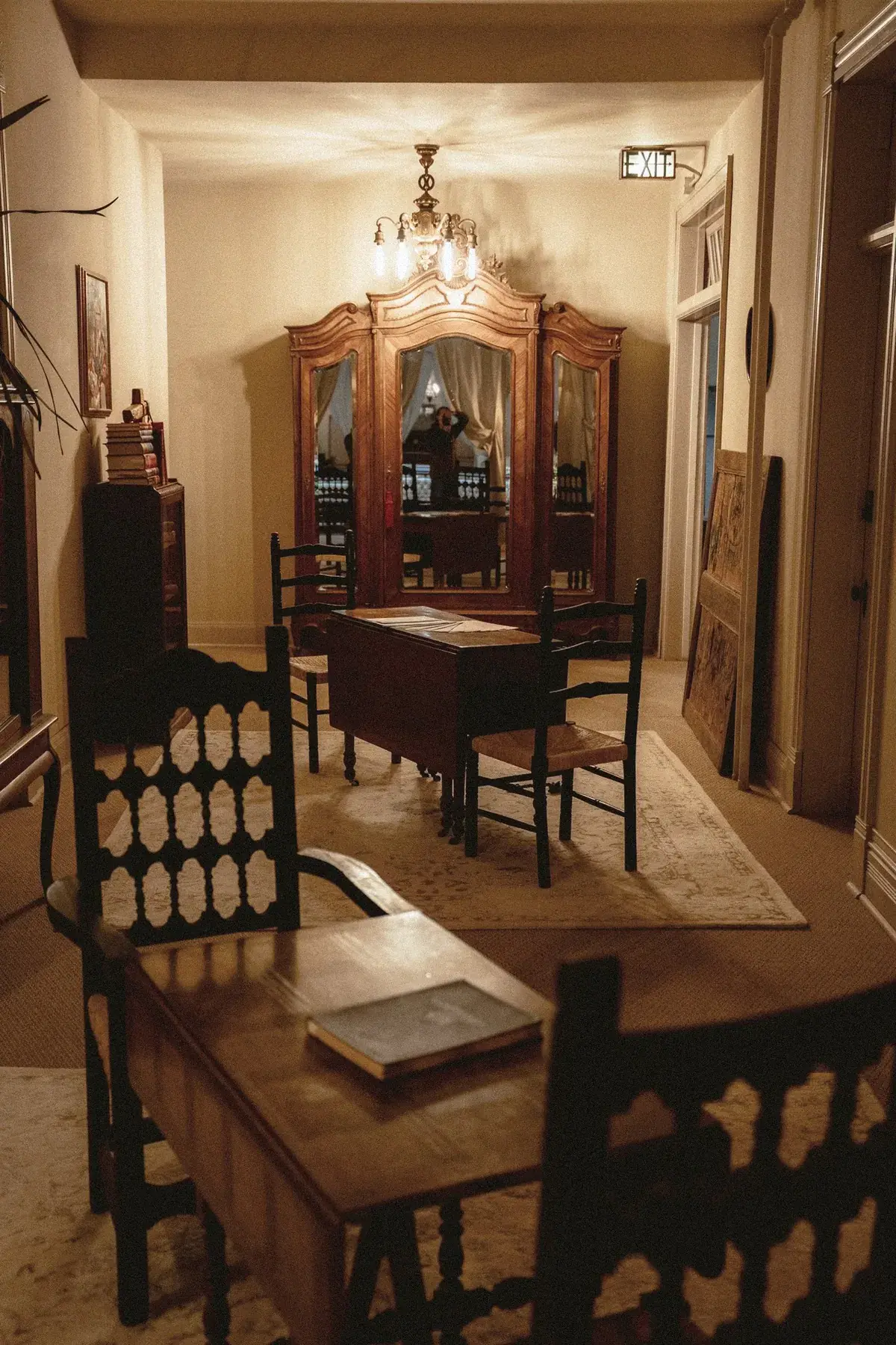 Long hallway with antique armoire and sitting area