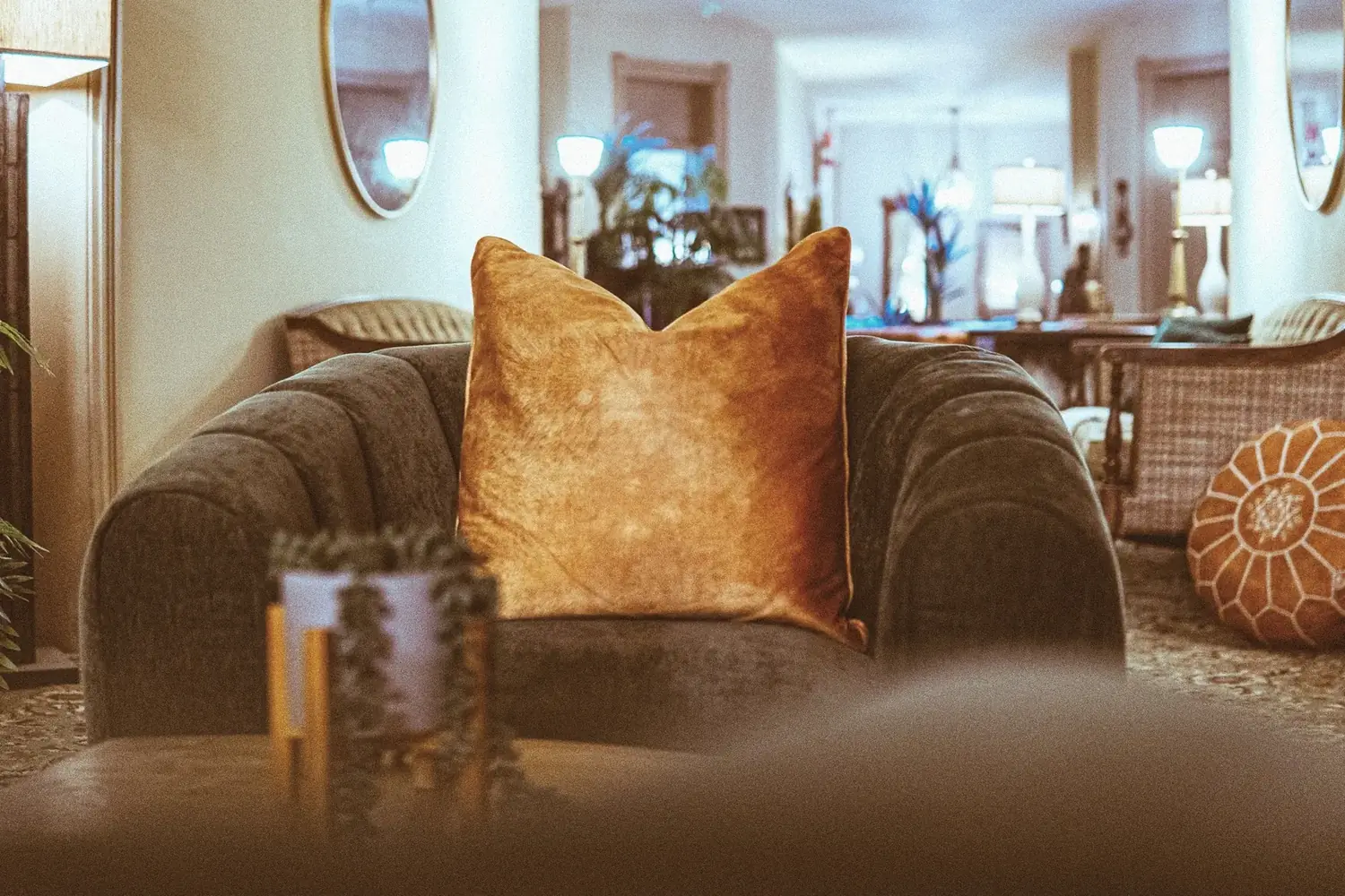 Plush armchair with amber pillow and soft lamp