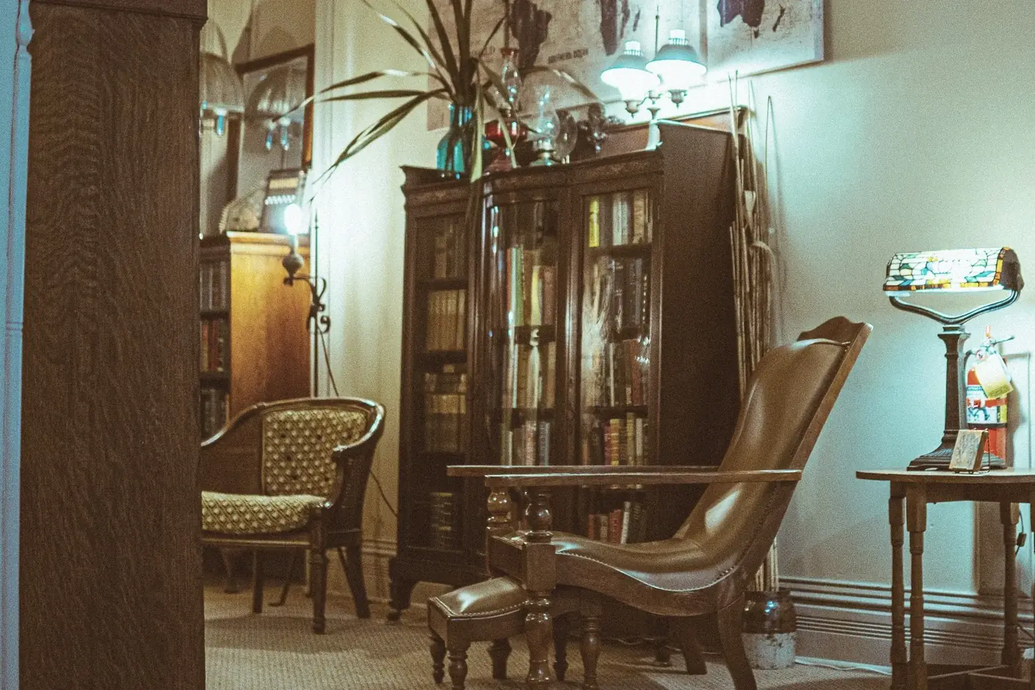 Library sitting area with leather chair and bookshelves