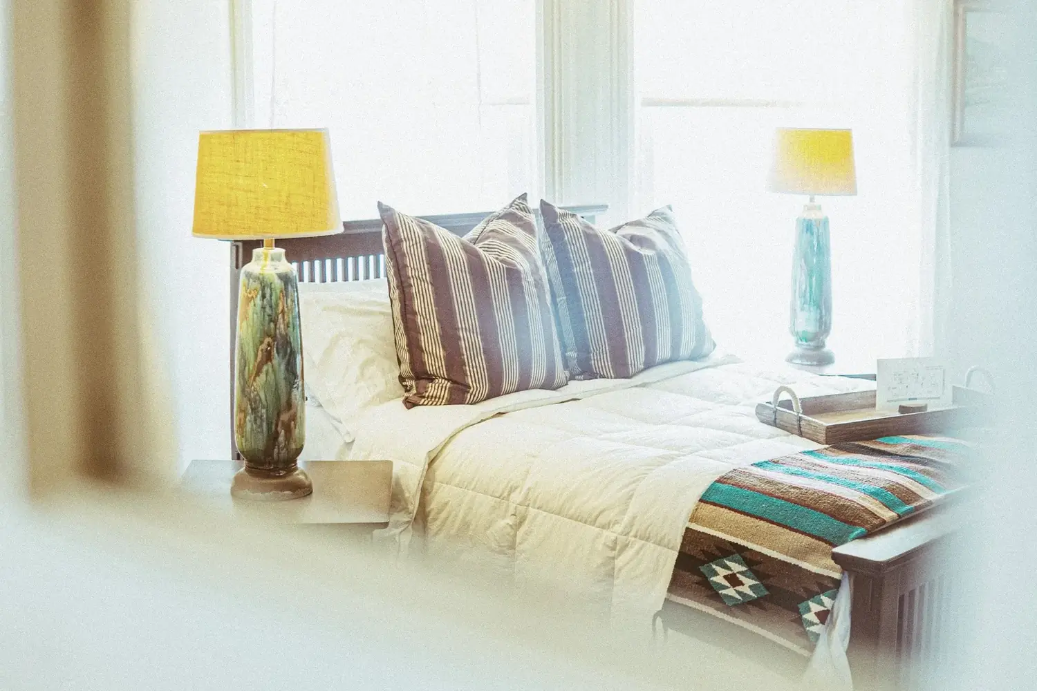 Bed scene with glowing lamps and textile detail